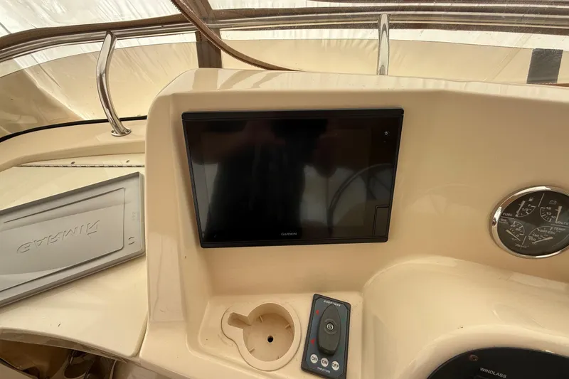 Slide: The Image of 2006 Mainship 34 Trawler interior with beige seating and canopy. - 10