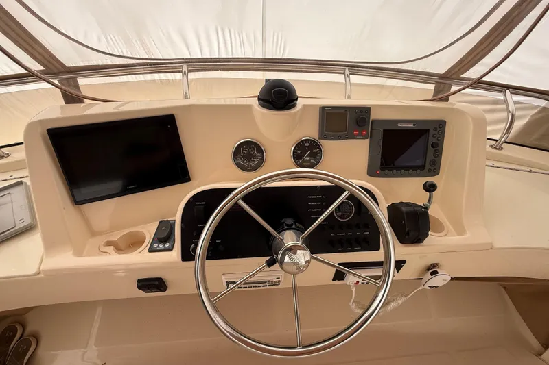 Slide: The Image of 2006 Mainship 34 Trawler helm with Garmin and Raymarine navigation systems. - 11