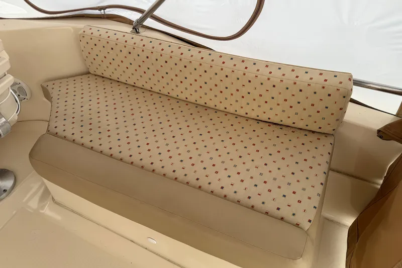 Slide: The Image of 2006 Mainship 34 Trawler helm with steering wheel, gauges, and navigation equipment. - 13