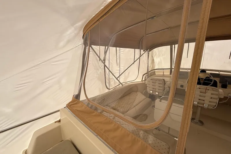 Slide: The Image of 2006 Mainship 34 Trawler interior seating with patterned upholstery and beige accents. - 15