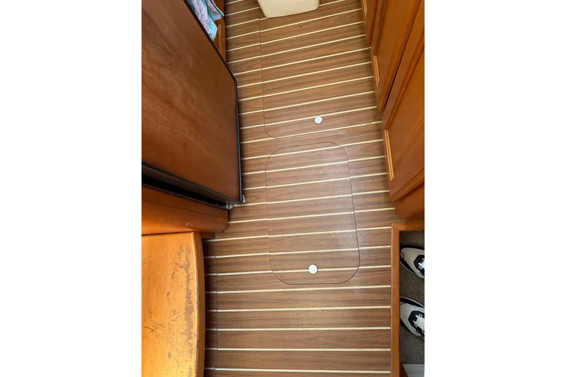 Slide: The Image of 2006 Mainship 34 Trawler kitchen with microwave, sink, and stove in compact layout. - 22