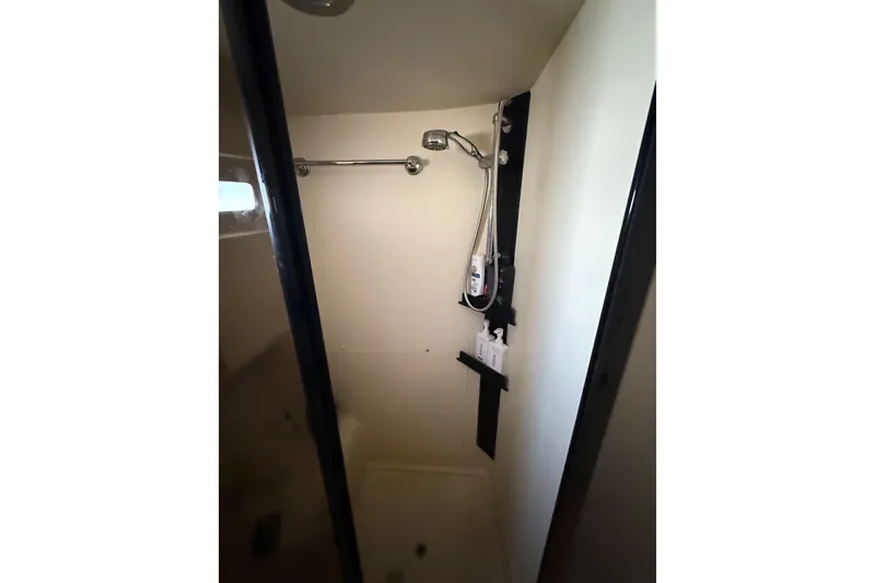 Slide: The Image of Cozy bedroom in 2006 Mainship 34 Trawler with elegant bedding and natural light. - 26