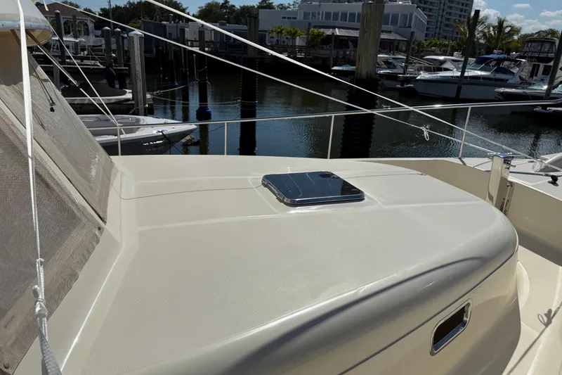 Slide: The Image of 2006 Mainship 34 Trawler docked, covered, with clear skies in the background. - 3