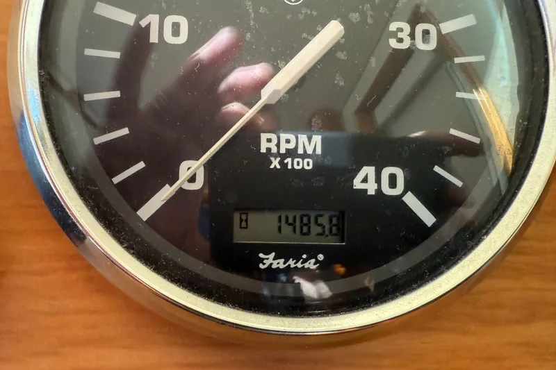 Slide: The Image of 2006 Mainship 34 Trawler dashboard with gauges, controls, and wooden steering wheel. - 30