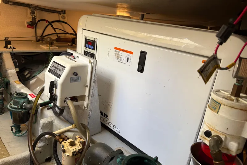 Slide: The Image of Engine room of 2006 Mainship 34 Trawler with visible engine and battery setup. - 37