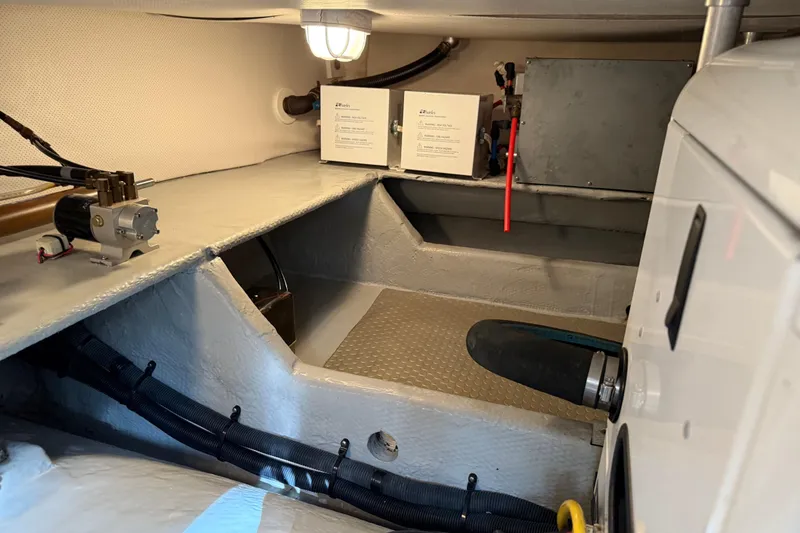 Slide: The Image of Engine room of 2006 Mainship 34 Trawler, showcasing equipment and maintenance area. - 38