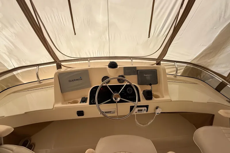 Slide: The Image of Interior view of 2006 Mainship 34 Trawler with beige canopy and railing. - 9
