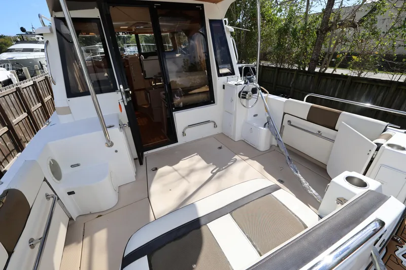 Slide: The Image of 2015 Ranger Tugs R-29 S boat deck with seating and steering wheel. - 10