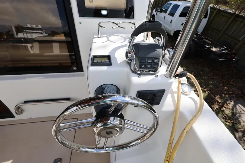 Slide: The Image of Steering console of 2015 Ranger Tugs R-29 S boat with chrome wheel and controls. - 12
