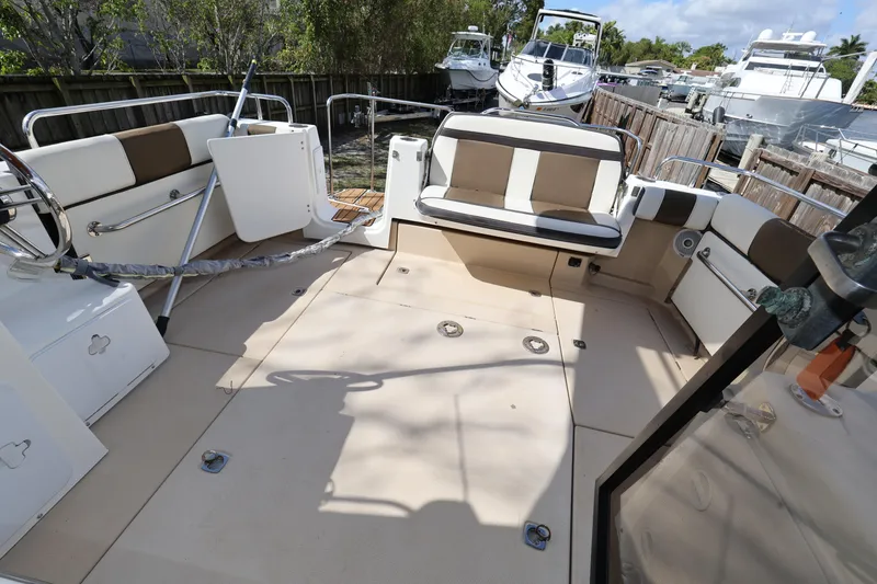 Slide: The Image of 2015 Ranger Tugs R-29 S boat deck with seating and steering wheel. - 13