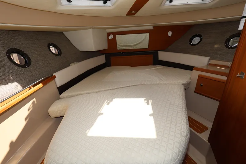 Slide: The Image of 2015 Ranger Tugs R-29 S interior cabin with bed and portholes. - 25