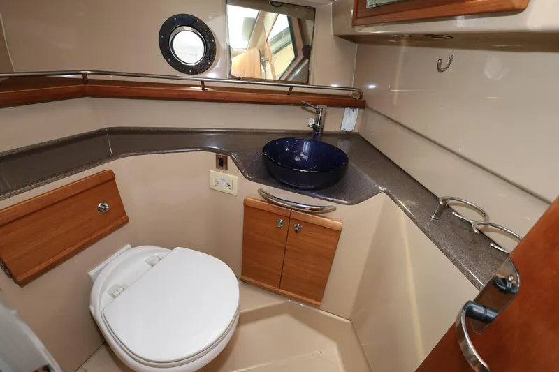 Slide: The Image of 2015 Ranger Tugs R-29 S bathroom with modern sink and wooden cabinetry. - 26