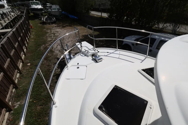 Slide: The Image of 2015 Ranger Tugs R-29 S boat deck with railing, parked near other boats. - 30