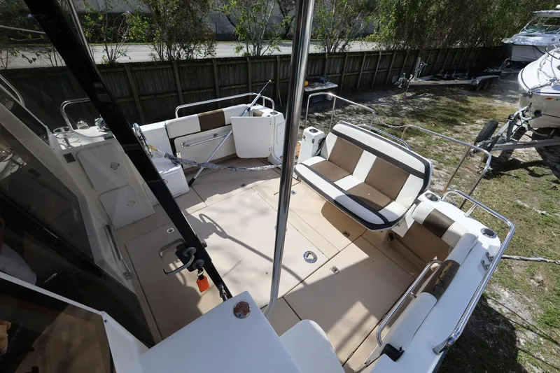 Slide: The Image of 2015 Ranger Tugs R-29 S boat deck with seating and railing in outdoor setting. - 31
