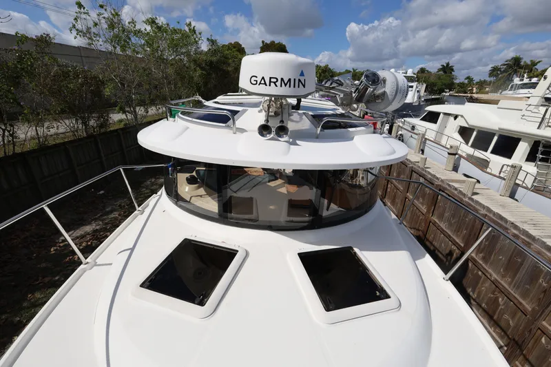 Slide: The Image of 2015 Ranger Tugs R-29 S boat with Garmin equipment, docked under a cloudy sky. - 32