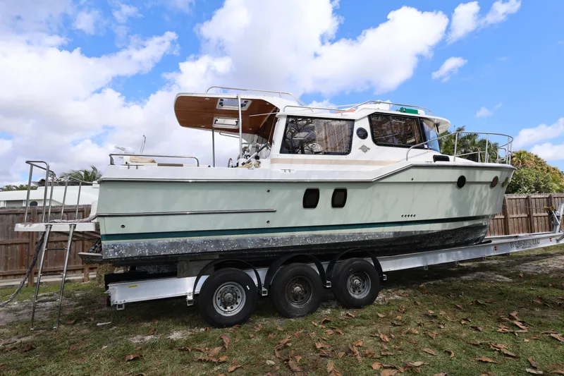 Slide: The Image of 2015 Ranger Tugs R-29 S boat on trailer under blue sky. - 6