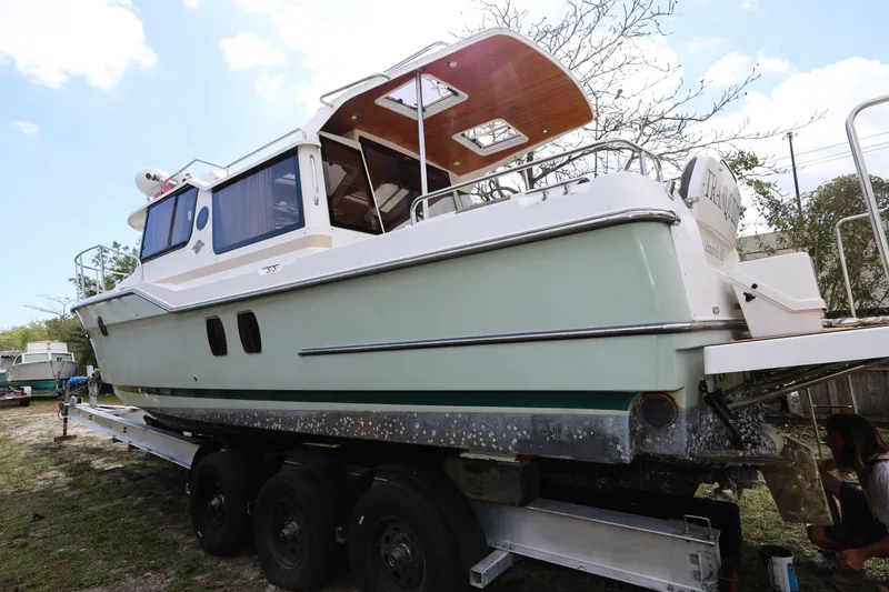 Slide: The Image of 2015 Ranger Tugs R-29 S boat on trailer, side view, outdoors. - 7
