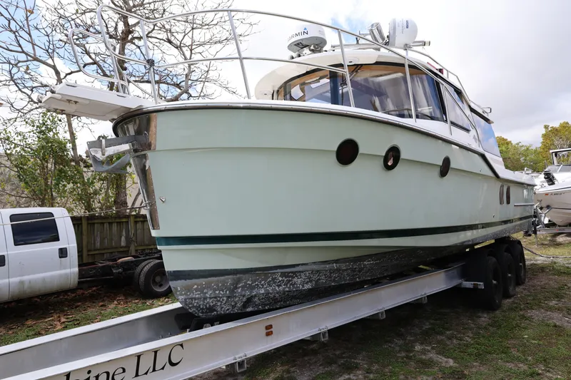 Slide: The Image of 2015 Ranger Tugs R-29 S boat on trailer, parked outdoors. - 8