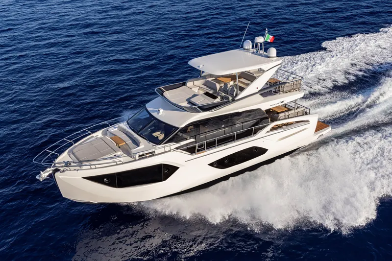 Slide: The Image of Luxury 2025 Absolute 56 FLY yacht cruising on open sea. - 2