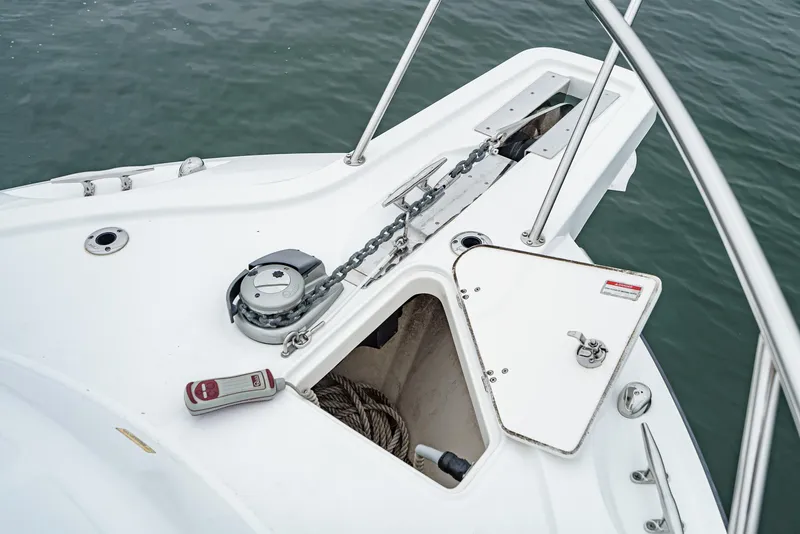Slide: The Image of 2008 Boston Whaler 345 Conquest anchor system on deck, featuring chain and storage compartment. - 10