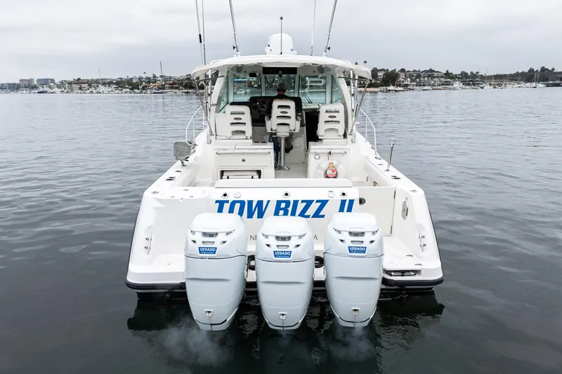 Slide: The Image of 2008 Boston Whaler 345 Conquest boat with triple engines on calm water. - 17