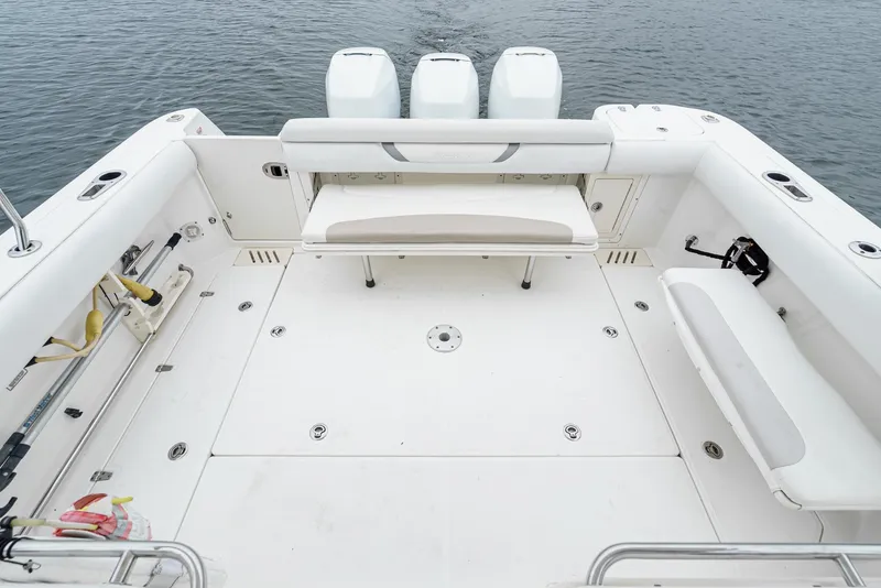 Slide: The Image of 2008 Boston Whaler 345 Conquest boat deck with seating and triple engines. - 21