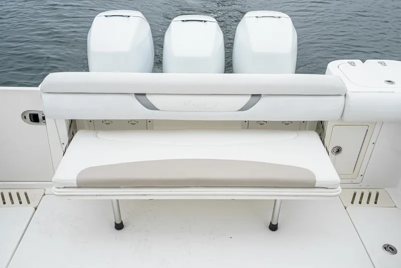 Slide: The Image of 2008 Boston Whaler 345 Conquest boat with triple outboard engines and foldable bench seat. - 22