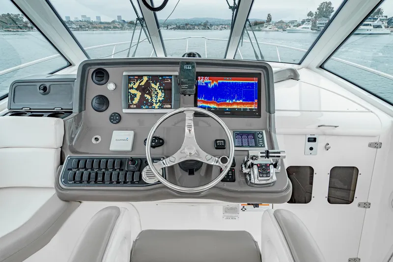 Slide: The Image of 2008 Boston Whaler 345 Conquest helm with navigation screens and steering wheel. - 35