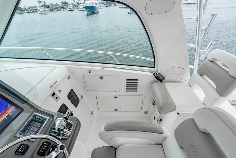 Slide: The Image of 2008 Boston Whaler 345 Conquest helm with modern controls and waterfront view. - 43