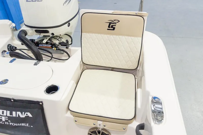 Slide: The Image of Manufacturer Provided Image: 2026 Carolina Skiff 25 LS boat seat with logo, featuring quilted upholstery and integrated speaker. - 12
