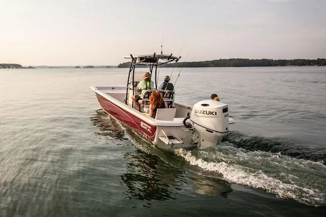 Slide: The Image of Manufacturer Provided Image: 2026 Carolina Skiff 25 LS boat cruising on a calm lake with passengers. - 2