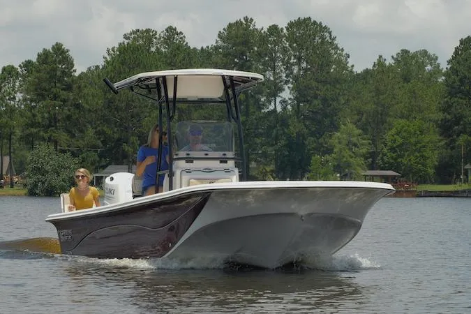 Slide: The Image of Manufacturer Provided Image: 2026 Carolina Skiff 25 LS boat cruising on a lake with passengers onboard. - 3