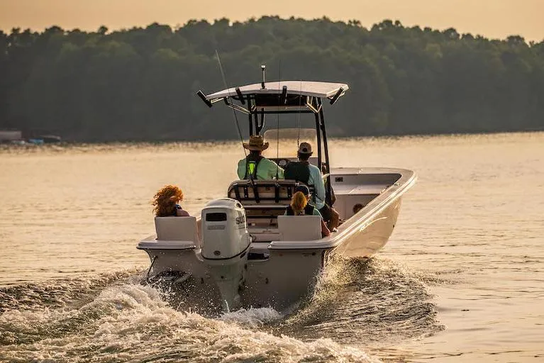 Slide: The Image of Manufacturer Provided Image: 2026 Carolina Skiff 25 LS boat cruising on a serene lake at sunset. - 5