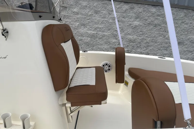Slide: The Image of 2026 Pioneer 180 Sportfish boat interior with brown and white seating. - 12