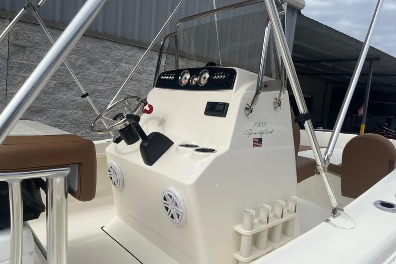 Slide: The Image of 2026 Pioneer 180 Sportfish boat console with steering wheel and gauges. - 14