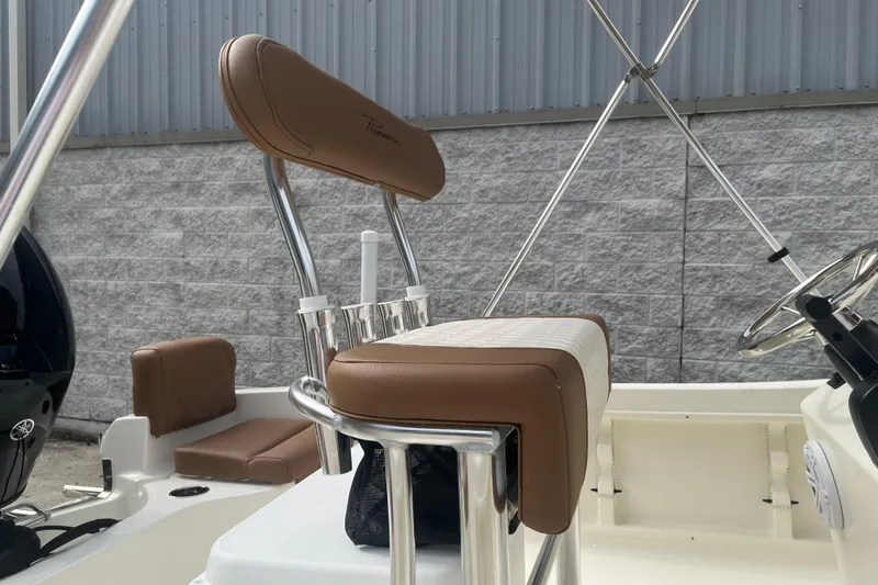 Slide: The Image of 2026 Pioneer 180 Sportfish boat interior with brown seating and steering wheel. - 17