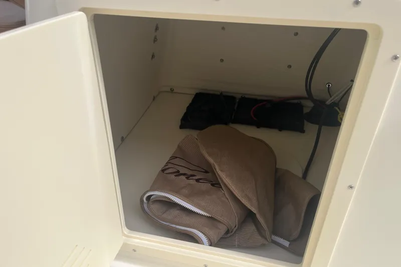 Slide: The Image of Open storage compartment in 2026 Pioneer 180 Sportfish boat with cover inside. - 23