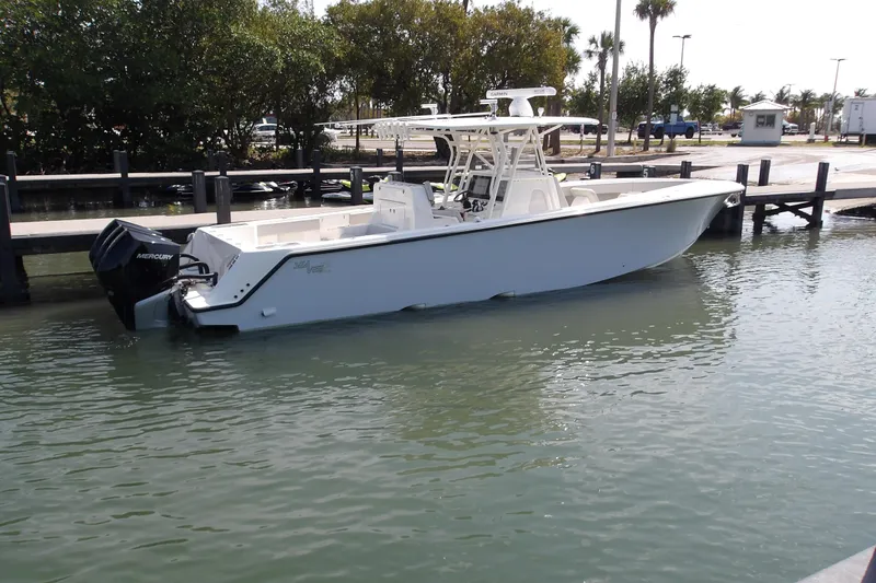 The Image of 2022 SeaVee 370Z boat docked in calm waters, featuring a sleek design and powerful Mercury engine. - 0