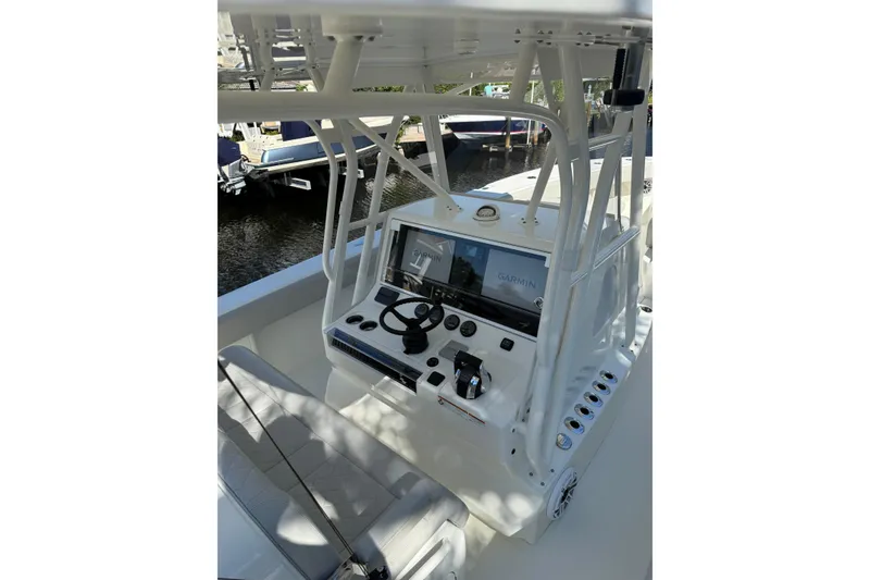 Slide: The Image of 2022 SeaVee 370Z boat console with Garmin navigation system and steering wheel. - 11