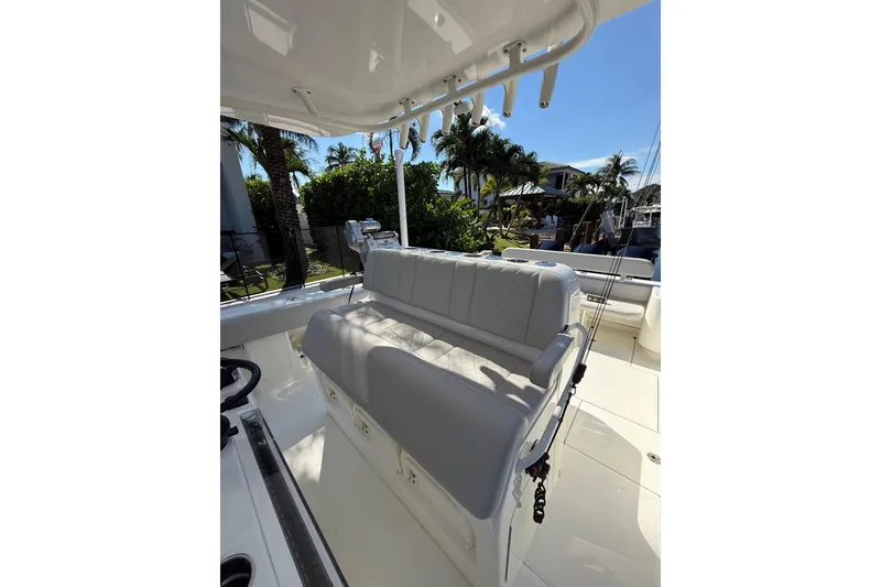Slide: The Image of 2022 SeaVee 370Z boat interior with cushioned seating and fishing rod holders. - 12