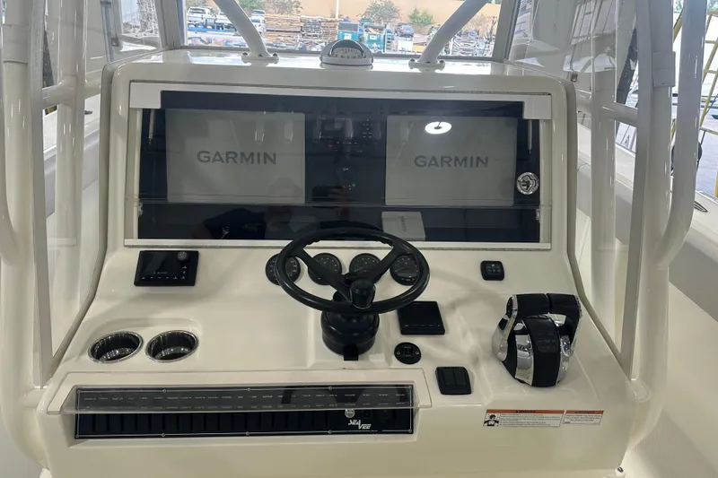 Slide: The Image of 2022 SeaVee 370Z boat dashboard with Garmin displays and steering wheel. - 4
