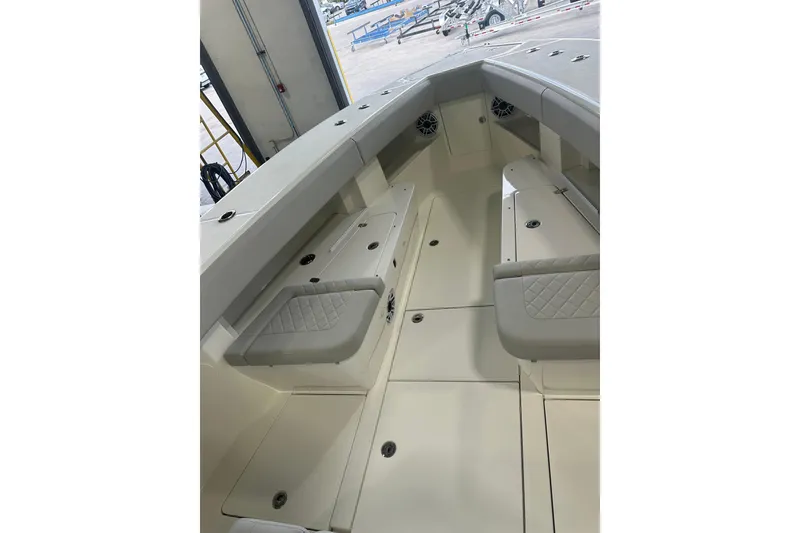 Slide: The Image of 2022 SeaVee 370Z boat interior with cushioned seating and storage compartments. - 5