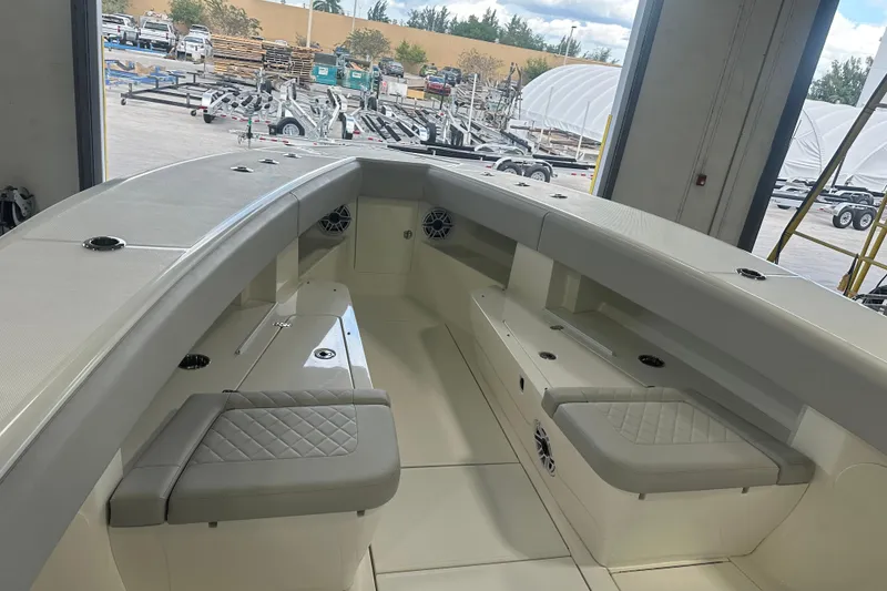 Slide: The Image of 2022 SeaVee 370Z boat interior with cushioned seating and storage compartments. - 6