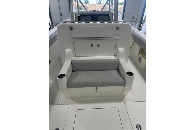 Slide: The Image of 2022 SeaVee 370Z boat interior with cushioned seating and cup holders. - 7