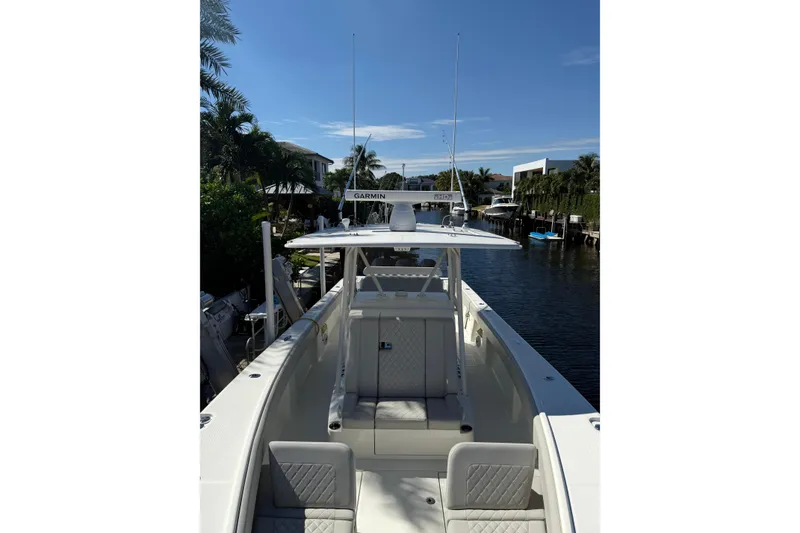 Slide: The Image of 2022 SeaVee 370Z boat docked in a scenic canal with clear skies. - 8