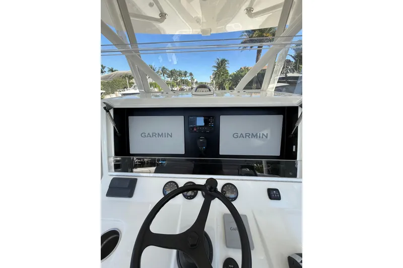 Slide: The Image of 2022 SeaVee 370Z boat dashboard with Garmin navigation displays and steering wheel. - 9