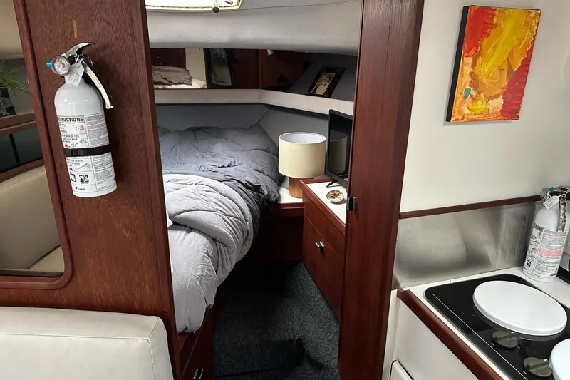 Slide: The Image of Interior of 1989 Tiara Yachts 3100 Flybridge with cozy cabin and kitchenette. - 7