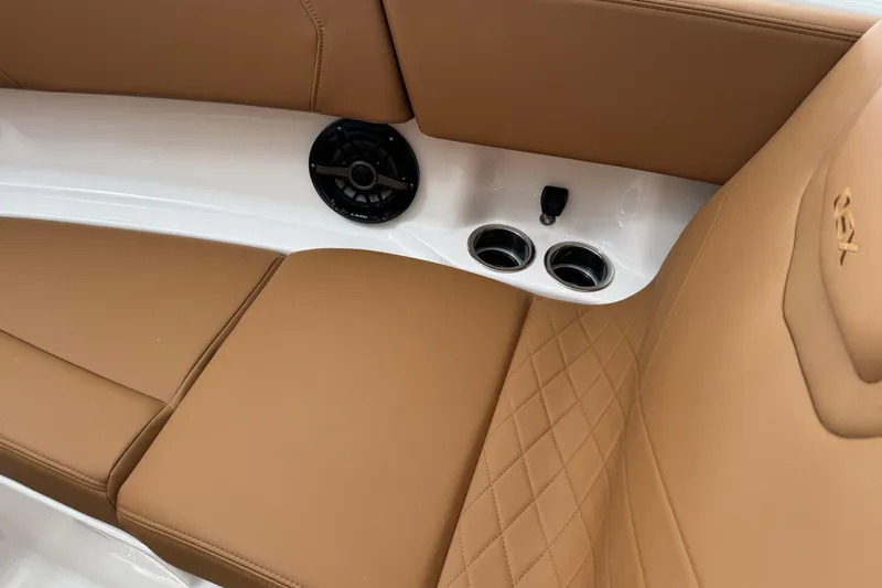 Slide: The Image of 2026 Chaparral 250 OSX boat interior with tan leather seats and cup holders. - 10