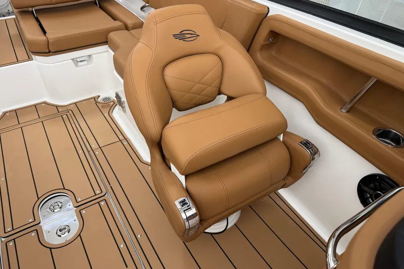 Slide: The Image of Luxurious tan interior of 2026 Chaparral 250 OSX boat, featuring premium seating and flooring. - 15
