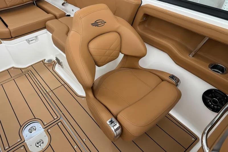 Slide: The Image of Luxurious tan seating in 2026 Chaparral 250 OSX boat interior. - 16